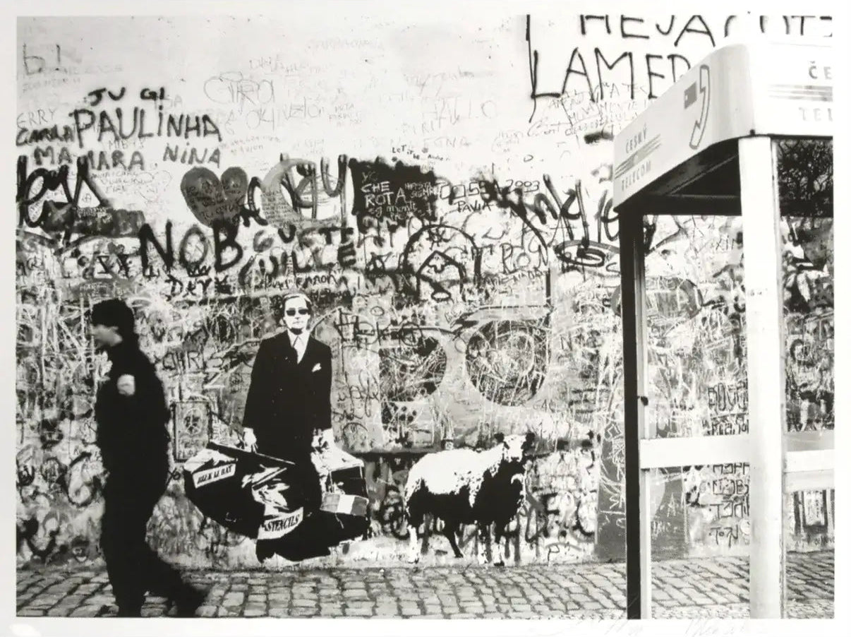Blek le Rat art print black and white street scene with people and a dog in front of a graffiti-covered wall.